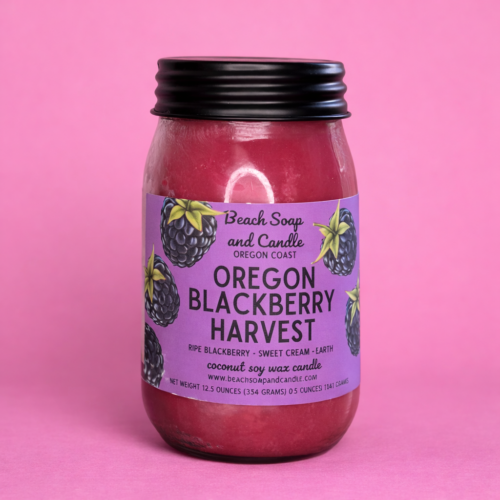 Jar candle labeled 'Oregon Blackberry Harvest' with a purple label on a pink background